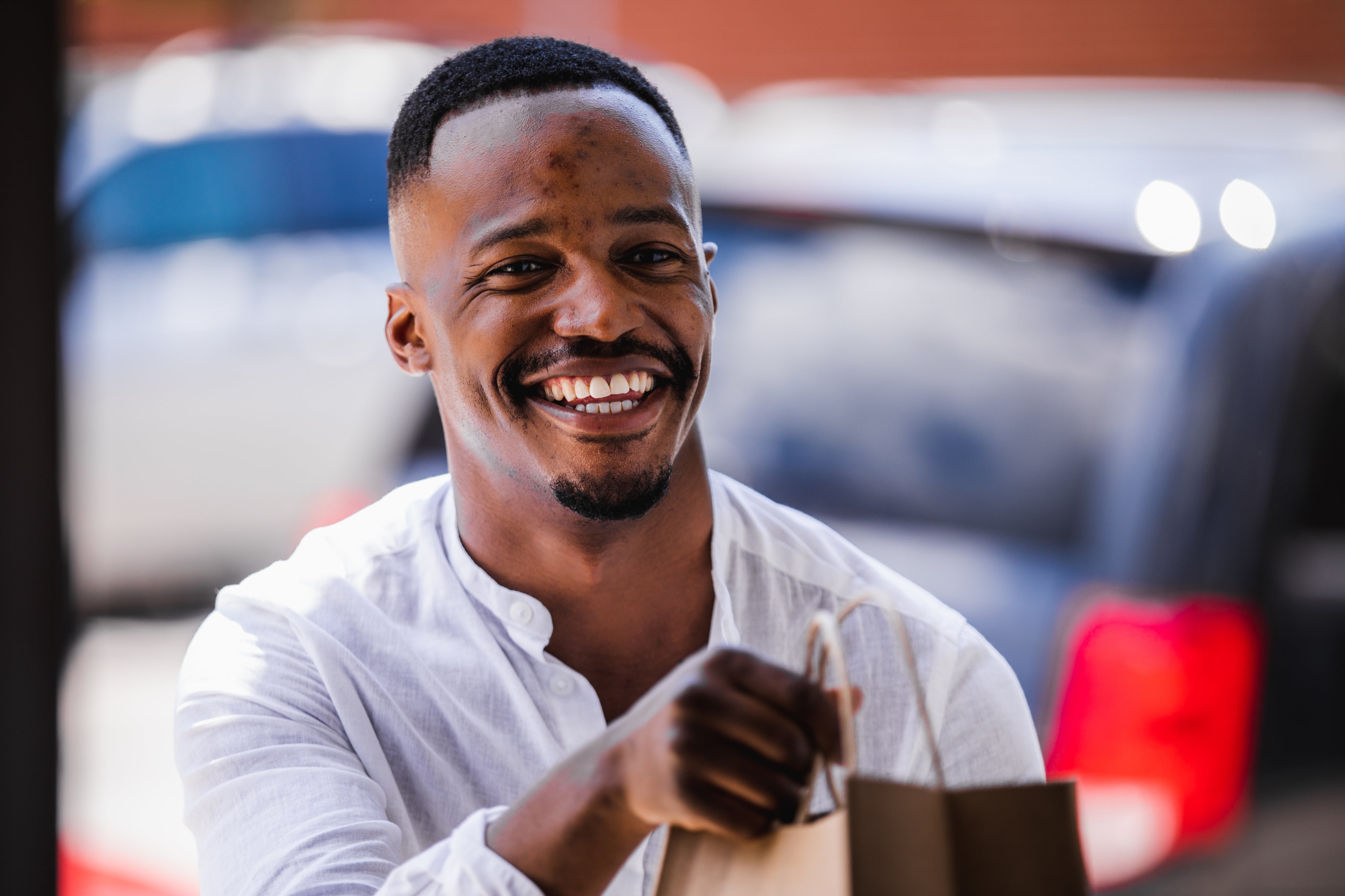 young-man-smiles-during-curb-side-pickup.jpg